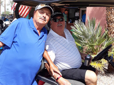 Residents with golf cart enjoying the day of sunny golf