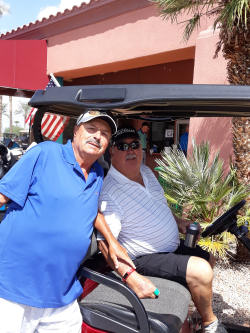 Photo of two older male residents enjoying a day of golf with their golf cart